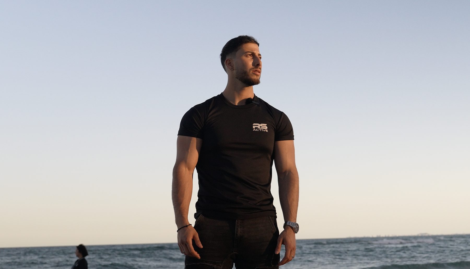 Anthony in RS Active kit on the beach at sunset